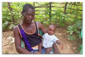 Félix Yvon Béfio and his baby who has just received the polio vaccine.