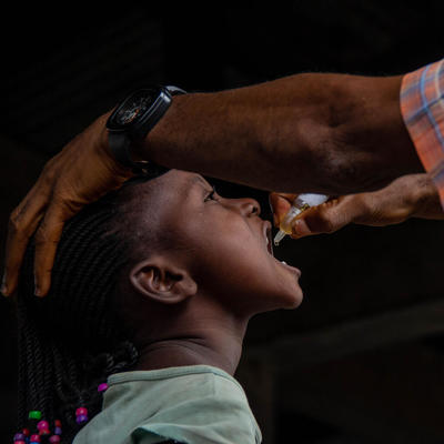 A child receiving polio drops