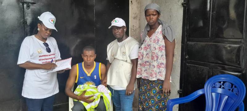 Supervising a door-to-door vaccination team at the Barry Household, where a 15-day-old infant lives.