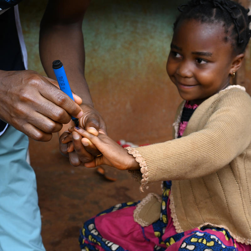 Little girl getting their pinky marked