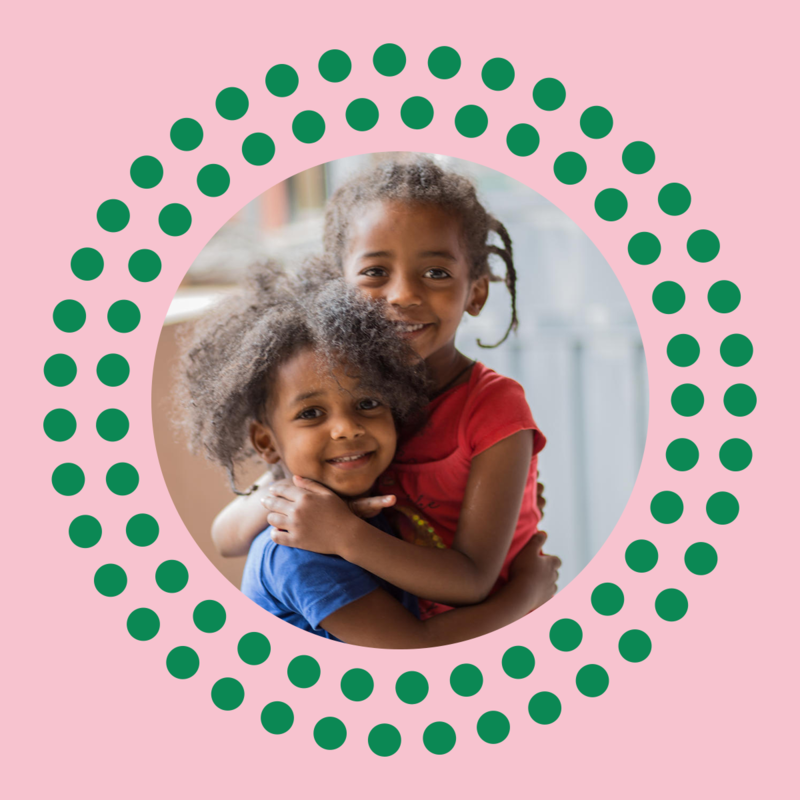 Two little girls hugging each other