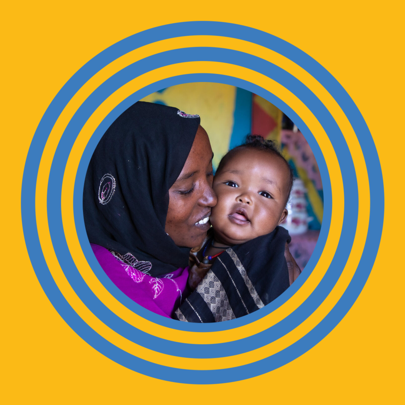 Mother kissing her baby