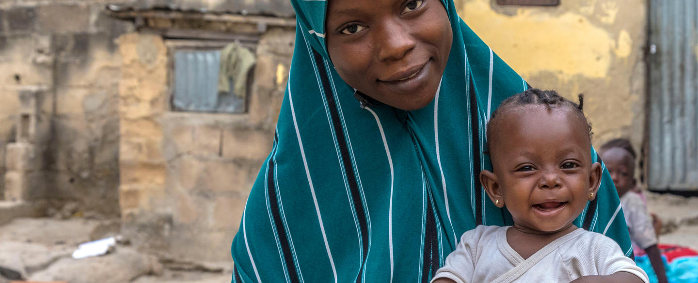 Woman holding child and smiling