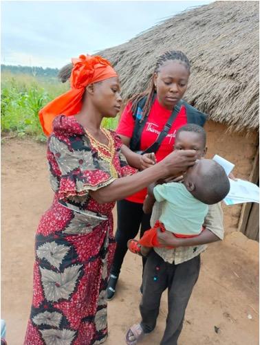 Mrs. Josephine administering a polio vaccine to a child during her door-to-door campaign in the Dibaya Health Zone. Photo: UNICEF/2024/DRC
