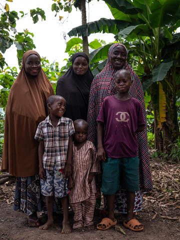 Three woman and three children looking at the camera