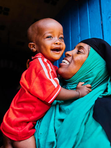 Mother holding her baby and smiling